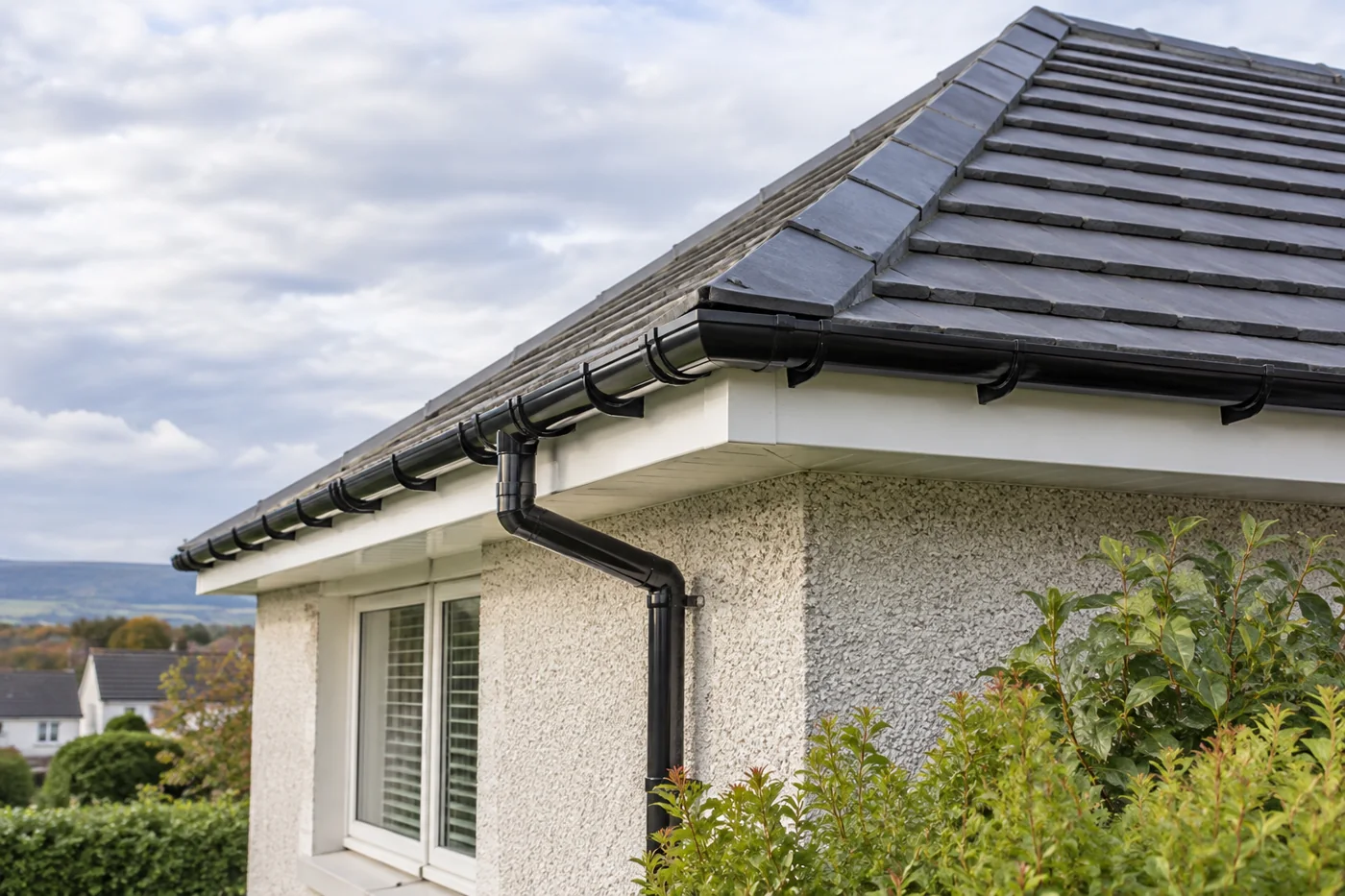 Guttering, fascia and downpipe beneath domestic roof eaves