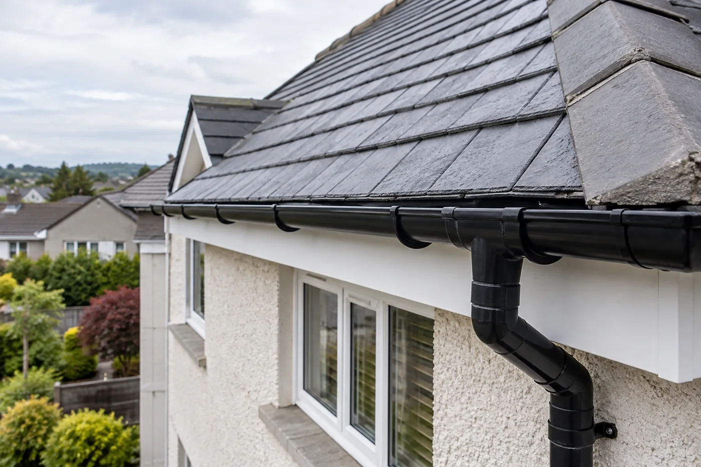 Guttering, fascia and downpipe beneath domestic roof eaves