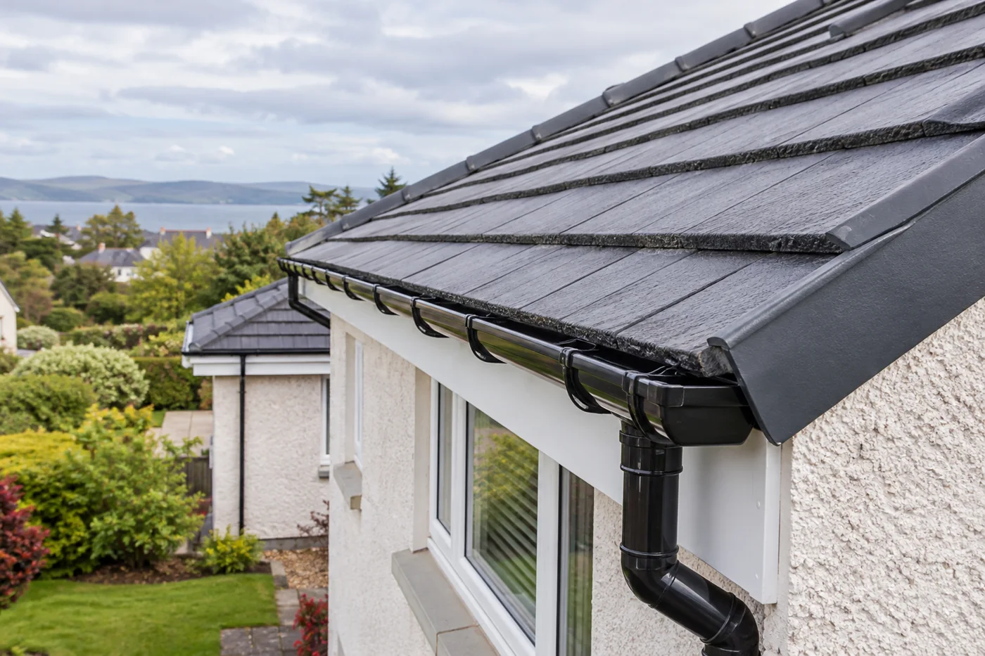 Guttering, fascia and downpipe beneath domestic roof eaves