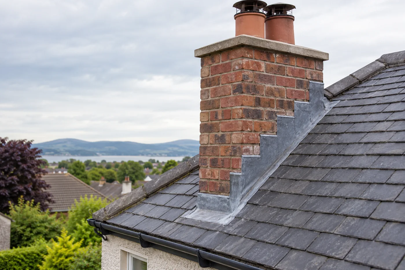 Brick chimney and stepped lead flashing