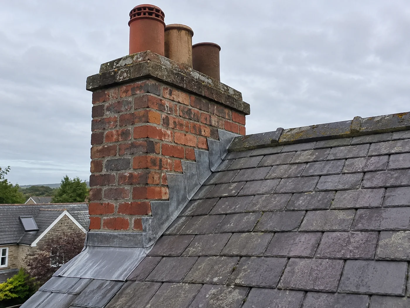 Brick chimney with pots and stepped lead flashing